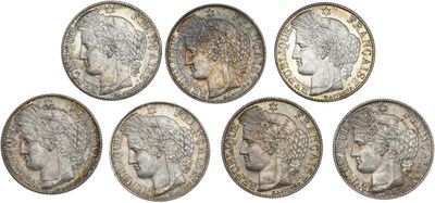 a group of six silver coins with heads of women on them