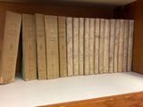 a lot of books that are on a shelf
