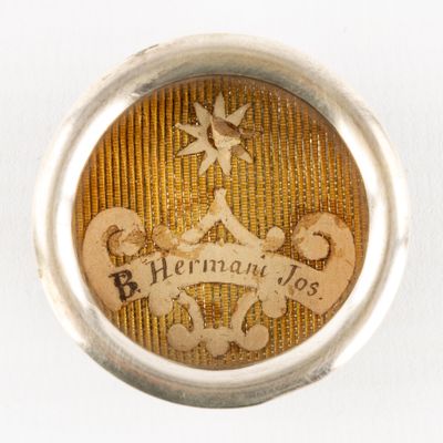 a silver ring with a picture of a man and a dog on it