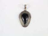 a silver pendant with a black stone in the center
