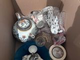 a box full of teapots and other items in it