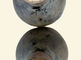 two vases sitting on top of each other on a table