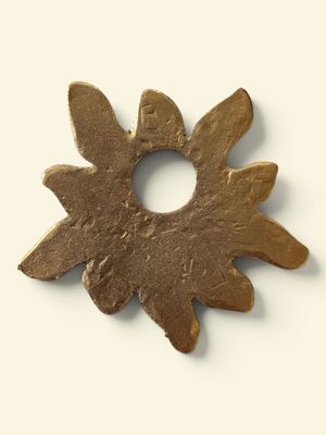 an image of a metal object with a flower in the middle