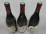 three bottles of wine sitting next to each other on a table