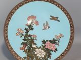 an image of a decorative plate with flowers and birds on it