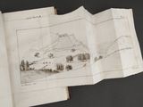a book with a drawing of a mountain in it
