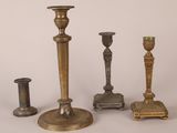 several different types of brass candlesticks on a white background