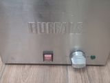 a large fryer sitting on a wooden floor in a kitchen
