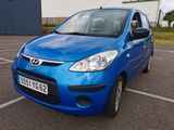 a picture of a blue car parked in a parking lot