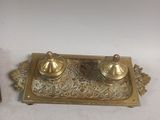 brass plate with two salt and pepper shakers on top of it