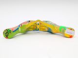 a colorful toothbrush on a white surface with a tag on it