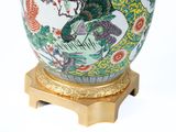 a vase with a dragon on it sitting on a stand