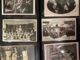 a lot of old black and white photos on a table