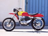 a red and yellow motorcycle parked in front of a building