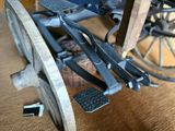 a close up of a wheelchair with wheels on the floor