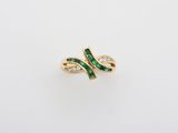 a gold ring with green and white stones