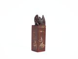 a small statue of a bird on a book