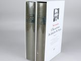 two books sitting on top of each other on a white surface