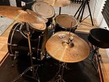 a drum set up in a recording studio with a microphone