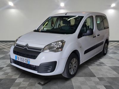 the white van is parked on a checkered floor in the garage