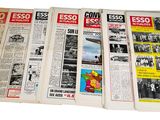 several old newspapers are stacked on top of each other on a white surface