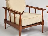 pair of mid - century danish lounge chairs with upholstered cushions