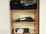 a closet with a lot of clothes on the shelves