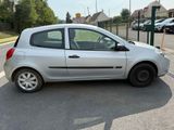 a small silver car parked in a parking lot