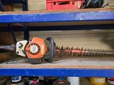a chainsaw that is sitting on a shelf in a garage