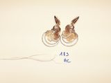 two pairs of earrings are shown with a price tag