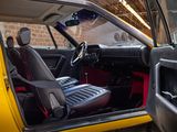 a yellow car with a red seat in the back of it