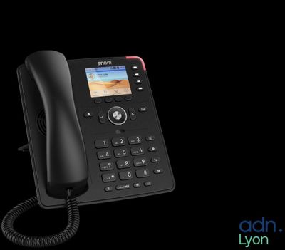 a close up of a phone with a cord on a black background