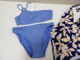 a blue bikini and a blue swim suit laying on a table