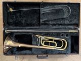 a brass trumpet in a black case on a table