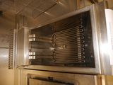 a silver oven with a bunch of cooking utensils inside of it