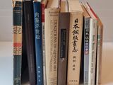 a lot of books that are stacked up on a table