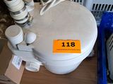 a white toilet sitting on top of a wooden table