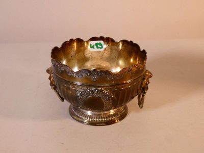 a silver bowl that has a green tag on it
