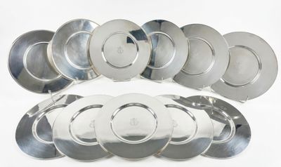 a lot of silver plates on a white surface