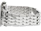 a silver watch that is sitting on a white surface