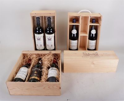 three bottles of wine in a wooden box on a table
