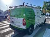 a green and white van parked on the side of the road