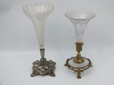 two glass vases sitting on top of a table next to each other
