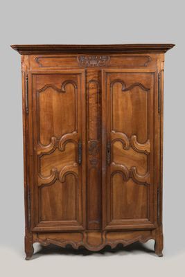 an old wooden cabinet with two doors and carvings on the front