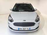 a white car that is parked in a white room