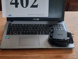 a laptop computer sitting on a wooden table with a mouse