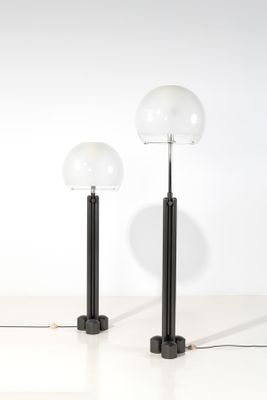deux lampes noires et blanches posées sur une surface blanche, avec un mur blanc en arrière-plan