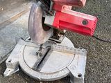 a picture of a red circular saw on the ground