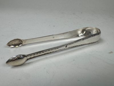 two spoons and a spoon rest on a white surface