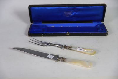 two forks and a knife in a case on a table